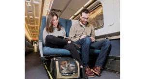 Amtrak customers Hannah Berkman and Luke Erickson take their dog, Boshi, on a trip on Amtrak’s Northeast Regional service.