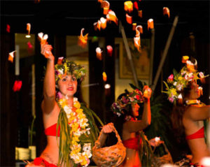 Polynesian dancers perform a traditional dance with flowers