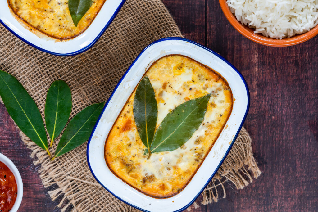 Bobotie - South African curried minced meat pie baked with egg-based ...