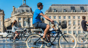 People riding bicycles in the mirror fountain