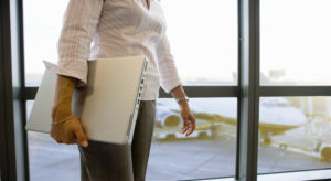 Businesswoman carrying laptop in airport