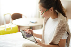 woman using iPad to order hotel service