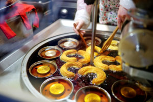 Delicious churros being baked at one of the stalls on the Christmas market in Vilnius, Lithuania