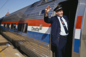 Train conductor waving from Amtrak train © Joe Sohm | Dreamstime.com