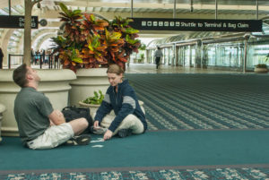 Couple on Airport floor waiting for flight