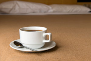 Micro hotel room with coffee and bed © Kenishirotie | Dreamstime.com