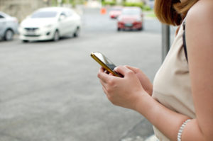 Woman using rideshare app on phone