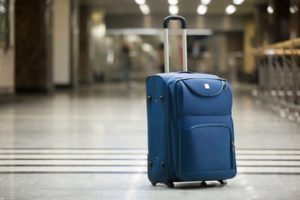 Blue suitcase at airport