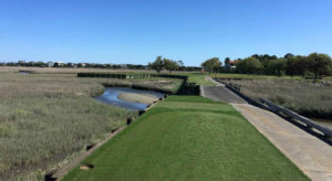 Hole 13 sports an earthen dike across a salt marsh.