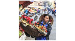 A woman sells flowers in Hanoi's Old Quarter