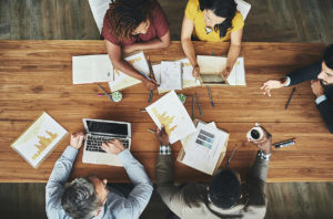 High angle shot of a team of businesspeople meeting around the boardroom table in the office