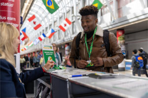 A passenger is provided with a Sunflower lanyard at one of O'Hare's 12 Information Desks. © Chicago Department of Aviation